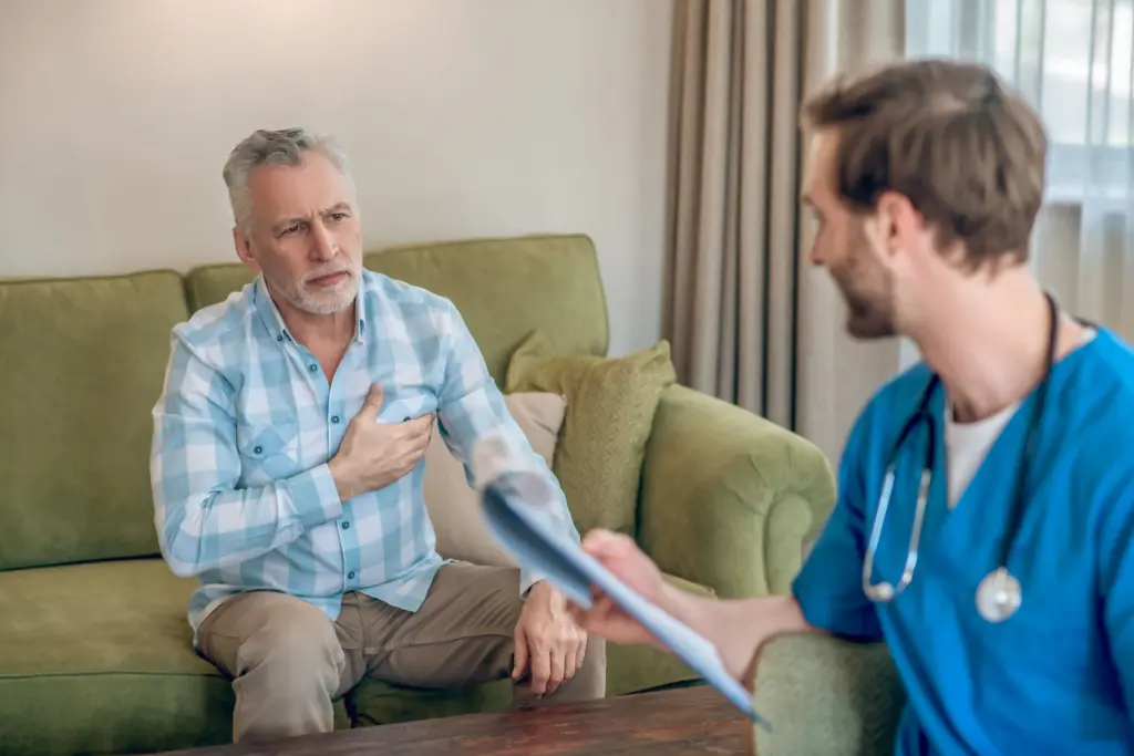 upset-gray-haired-man-plaid-shirt-complaining-his-chest-pain-cardiologis